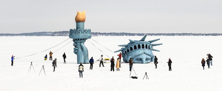 An inflated replica of the Statue of Liberty is erected on a frozen Lake Mendota near the Memorial Union