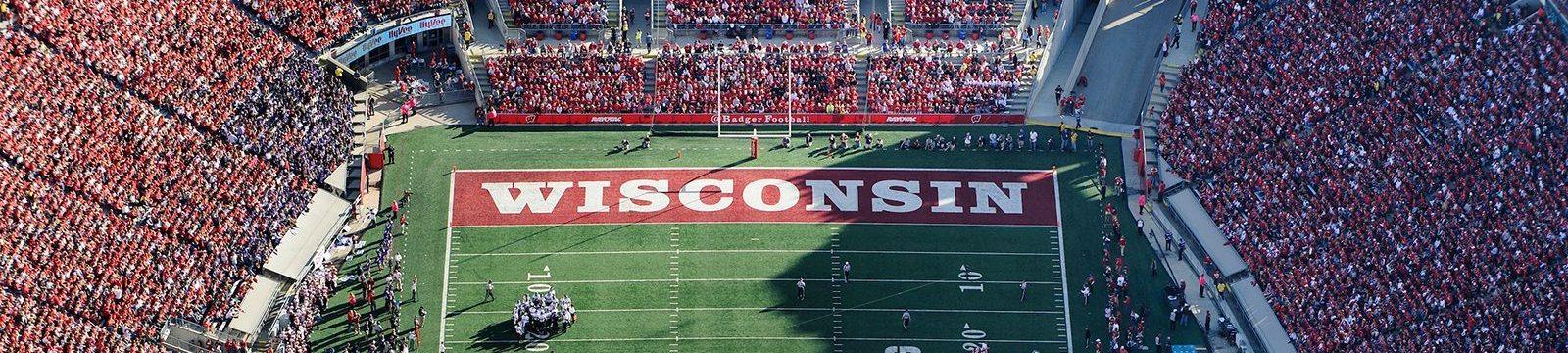 Aerial photo of the Camp Randall end zone during a Badger game with the stands filled with fans dressed in red