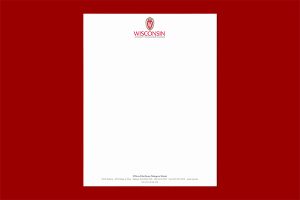 Sheet of letterhead paper on a dark red background
