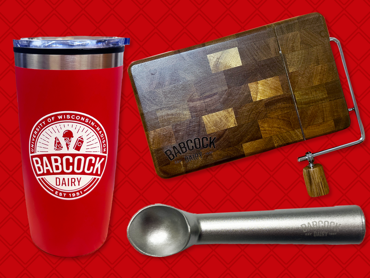 Three items from Babcock Dairy: a red tumbler, an wooden slicing board and an ice cream scoop.