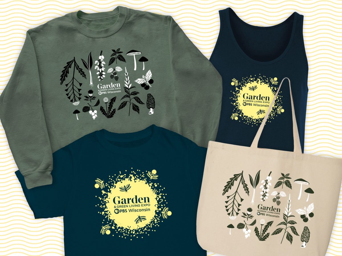 A display of PBS Wisconsin’s Garden & Green Living Expo merchandise -- including a green sweatshirt, navy tank top, navy t-shirt, and beige tote bag—featuring botanical illustrations and bee-themed graphics that celebrate eco-friendly living.