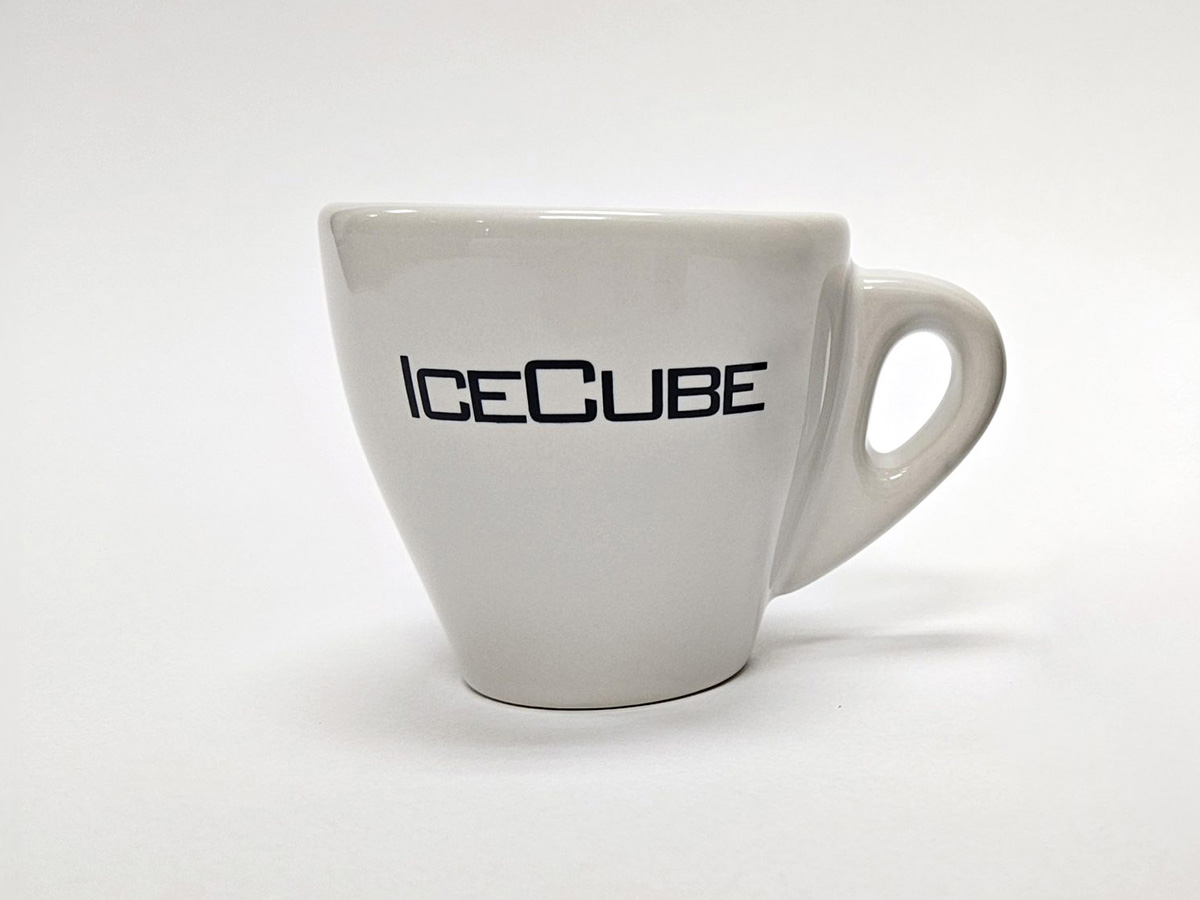 White ceramic espresso cup with the word ‘IceCube’ printed in black on the front, placed against a plain white background.