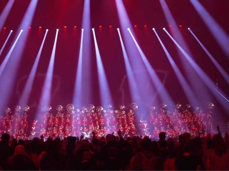 A marching band under spotlights
