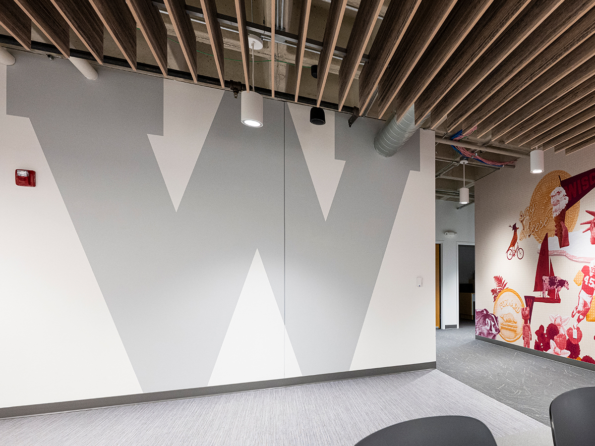 After photo of a wall with a large painted "W" on the surface