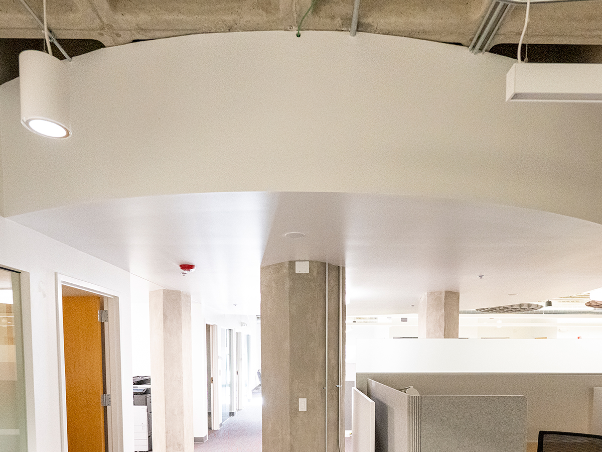 Before photo of a plain circular architectural feature within an office space.