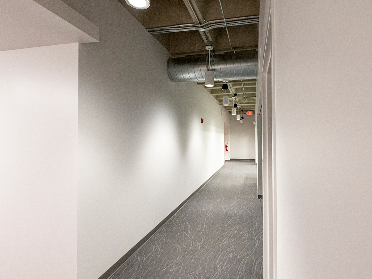 Before photo of a long corridor without any branding on the walls.
