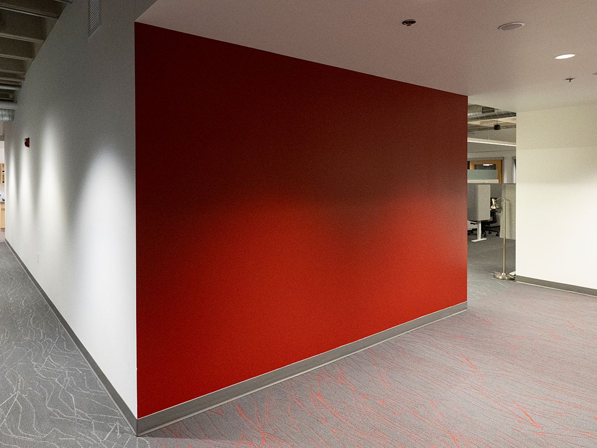 Before photo of a red entry wall in an office setting without branding applied 