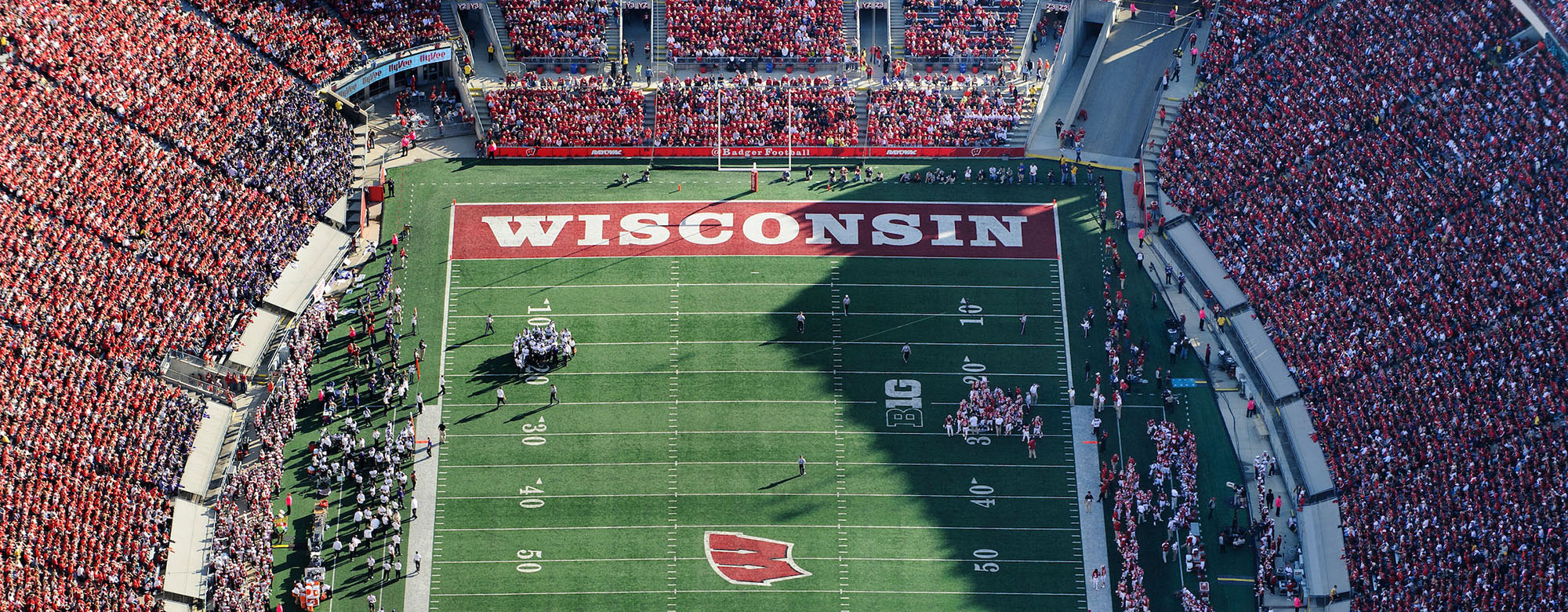 Aerial photo of the Camp Randall end zone during a Badger game with the stands filled with fans dressed in red